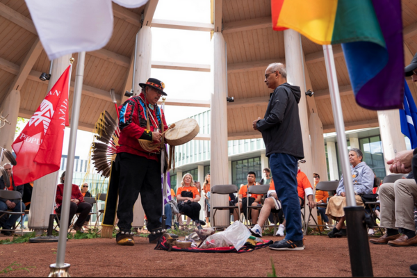 President Goel and Elder Myeengun standing in a circle of people exchanging words