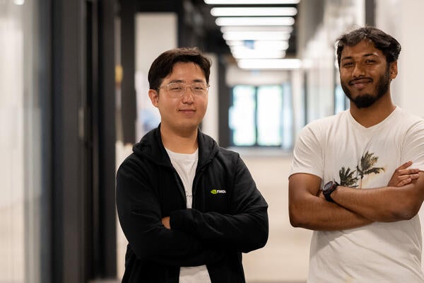 Seungmin Hong and Ahnaf Shahriar pose together with their arms crossed
