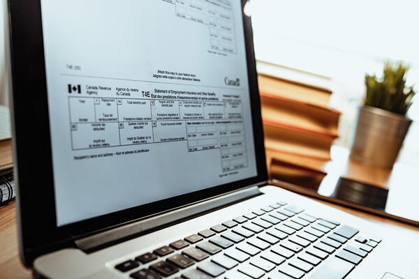 Close up of an open laptop with a section of a tax form visible on the screen