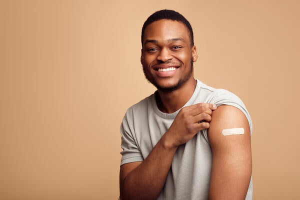 Portrait Of Vaccinated African Man Showing His Arm