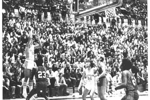 Phil Goggins throws a basketball during a championship game