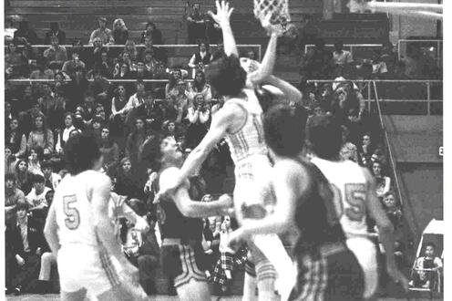 Waterloo Warriors players jump up to defend the opposing player's shot during a game