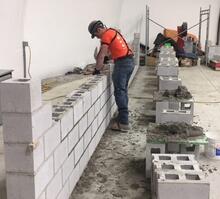 Worker working with bricks