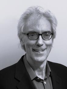 David Hand wearing dark framed glasses in black and white photo