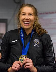 Hannah Blair with medal around her neck