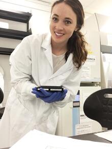 Victoria holding lab equipment