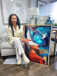 Kemahee Baker poses with a painting of a butterfly