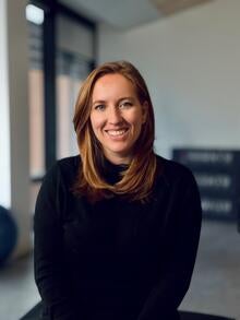 smiling woman seated on a chair