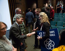 Director of SDSN Jeffrey Sachs shakes the hand of an attendee.