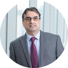Profile photo of Dr. Zahid Butt in a grey suit with purple tie