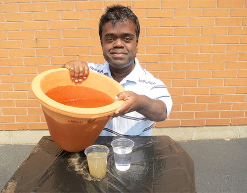 Timothy Muttoo holds the clay water filter he designed