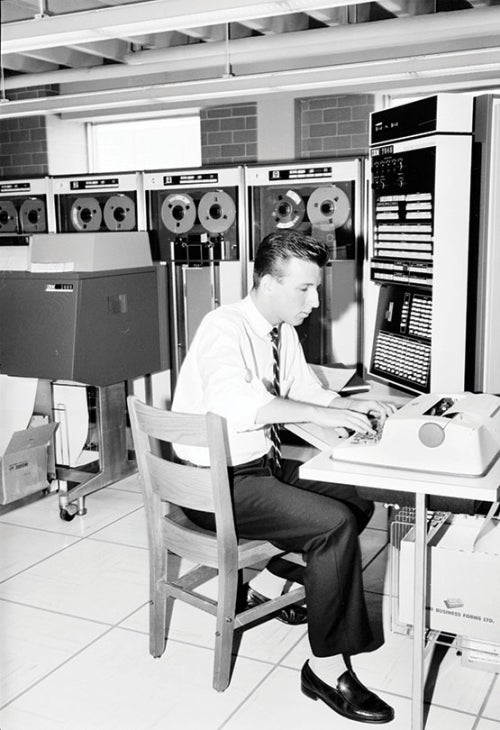 student working in 1960s computer lab