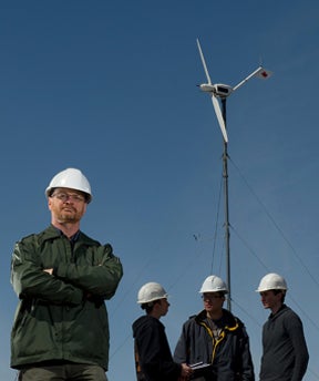 David Johnson stands in front of wind turbine
