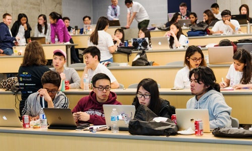 Groups of students working in Hackathon classroom