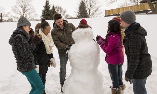 People building a snowman.