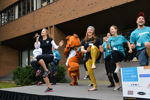 Warmup leaders dance on a stage