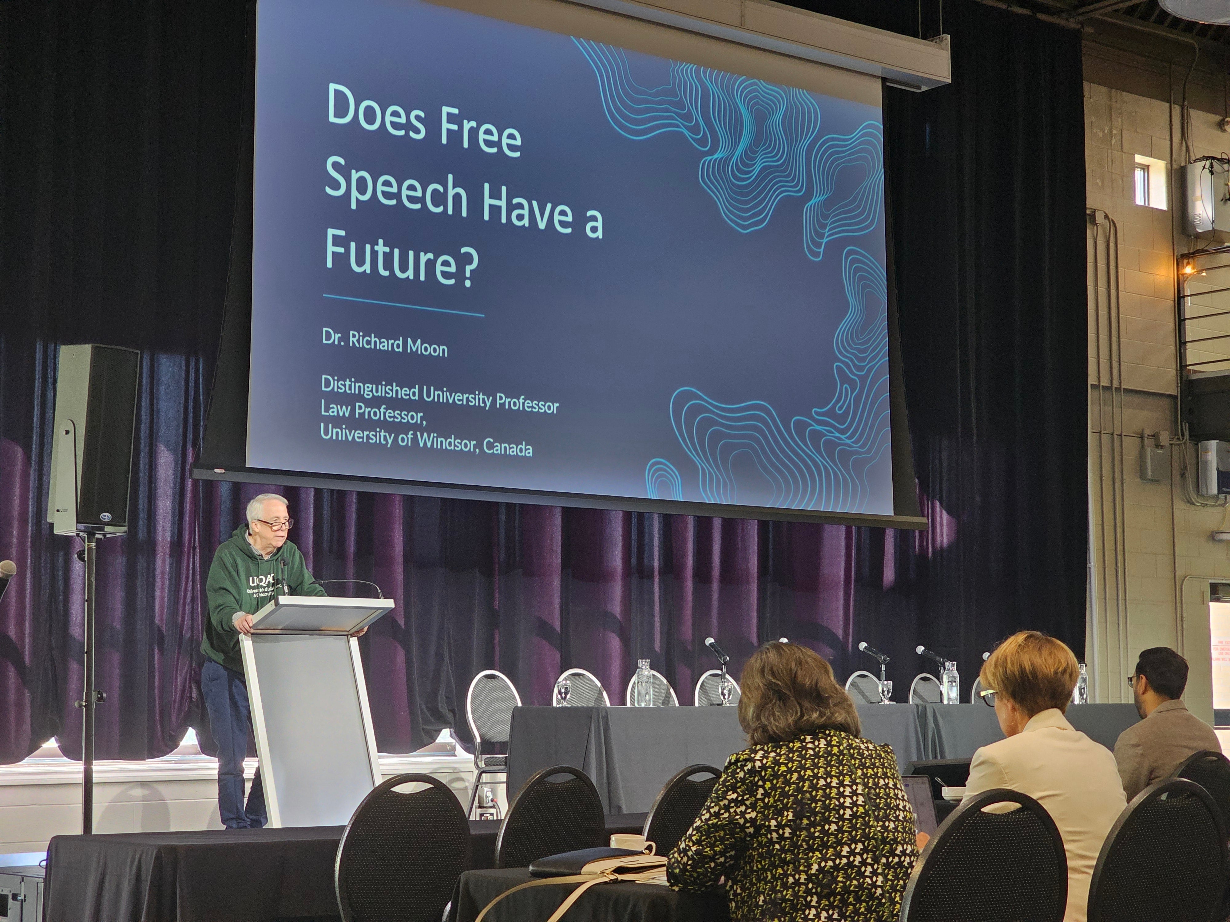 Dr. Richard Moon stands at podium during his keynote address