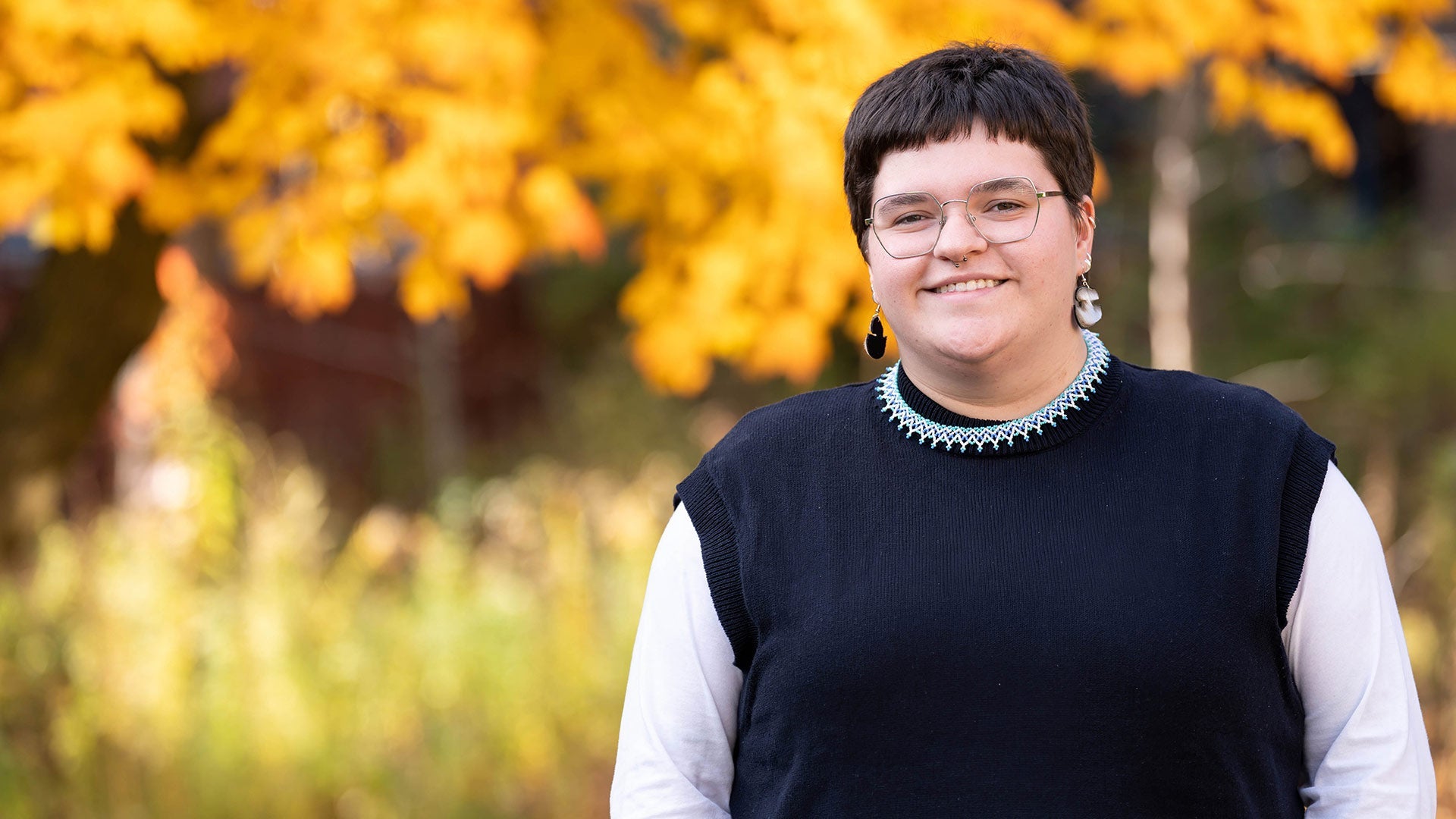 Tara Ryan poses near foliage with fall colours