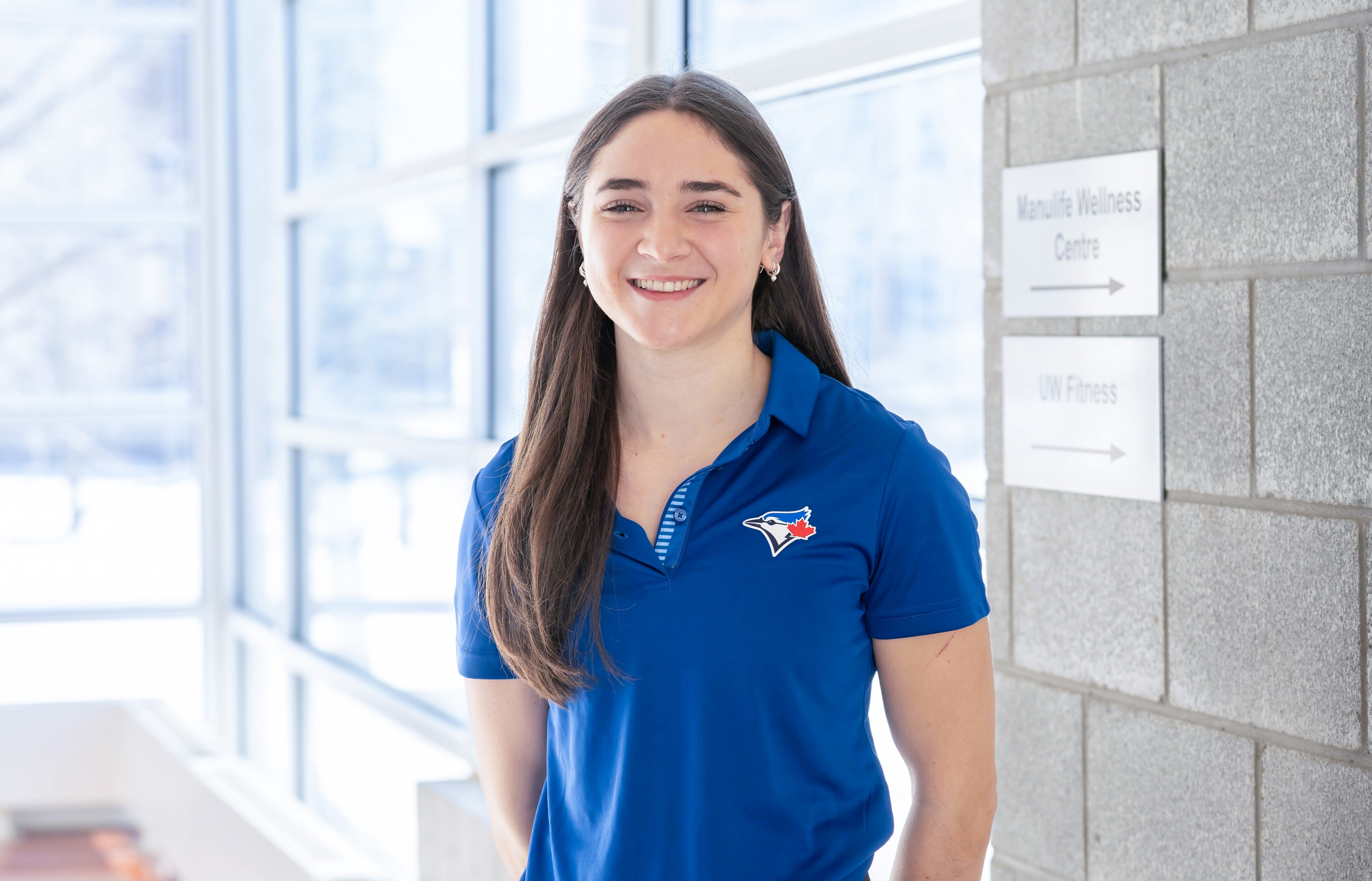 Juliana Bossom poses while wearing a blue jays shirt