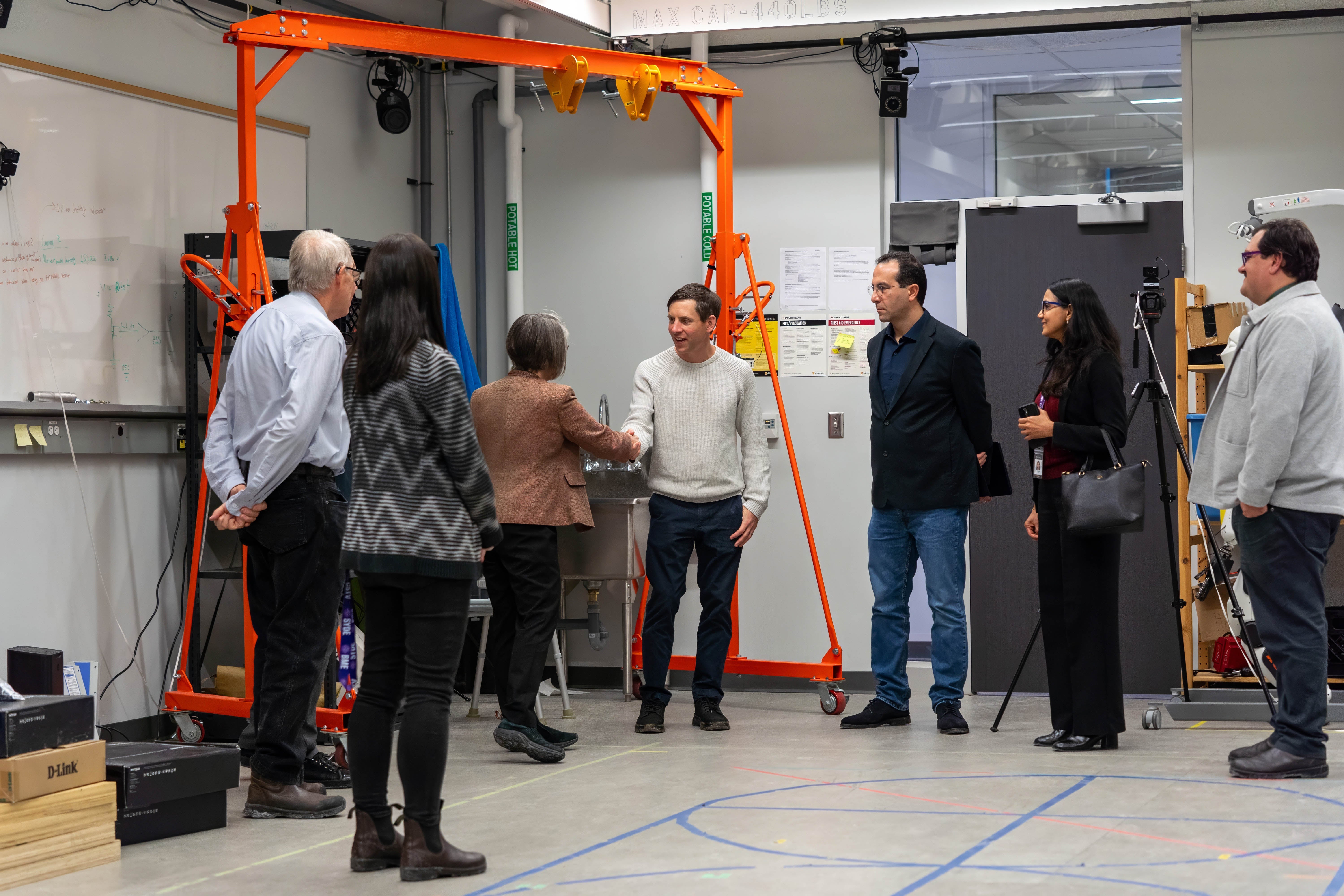 OceanMD delegation visit a UWaterloo robotics lab. Doug Kavanagh shakes the hand of Lisa Aultman-Hall