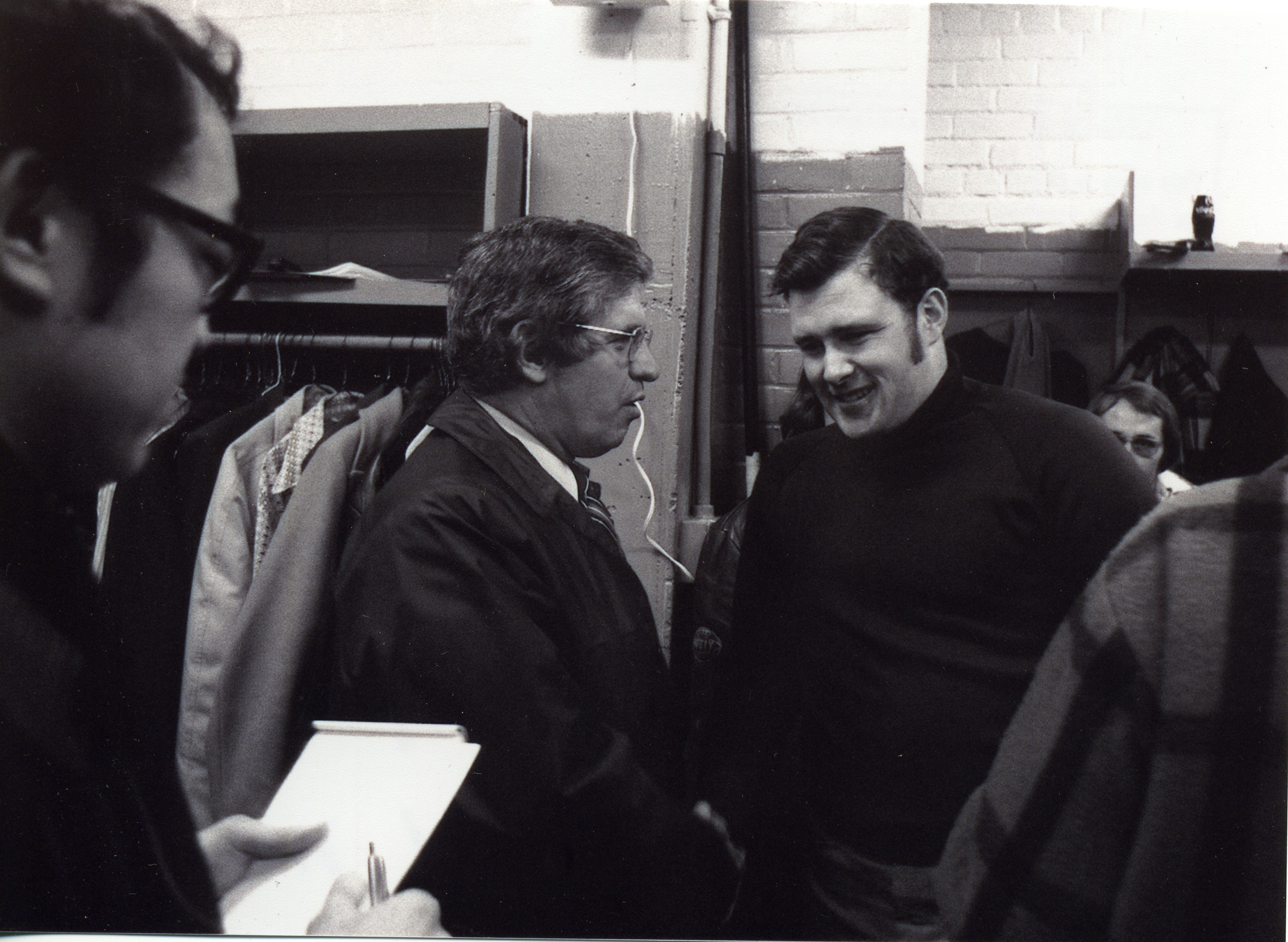 Coach with reporters