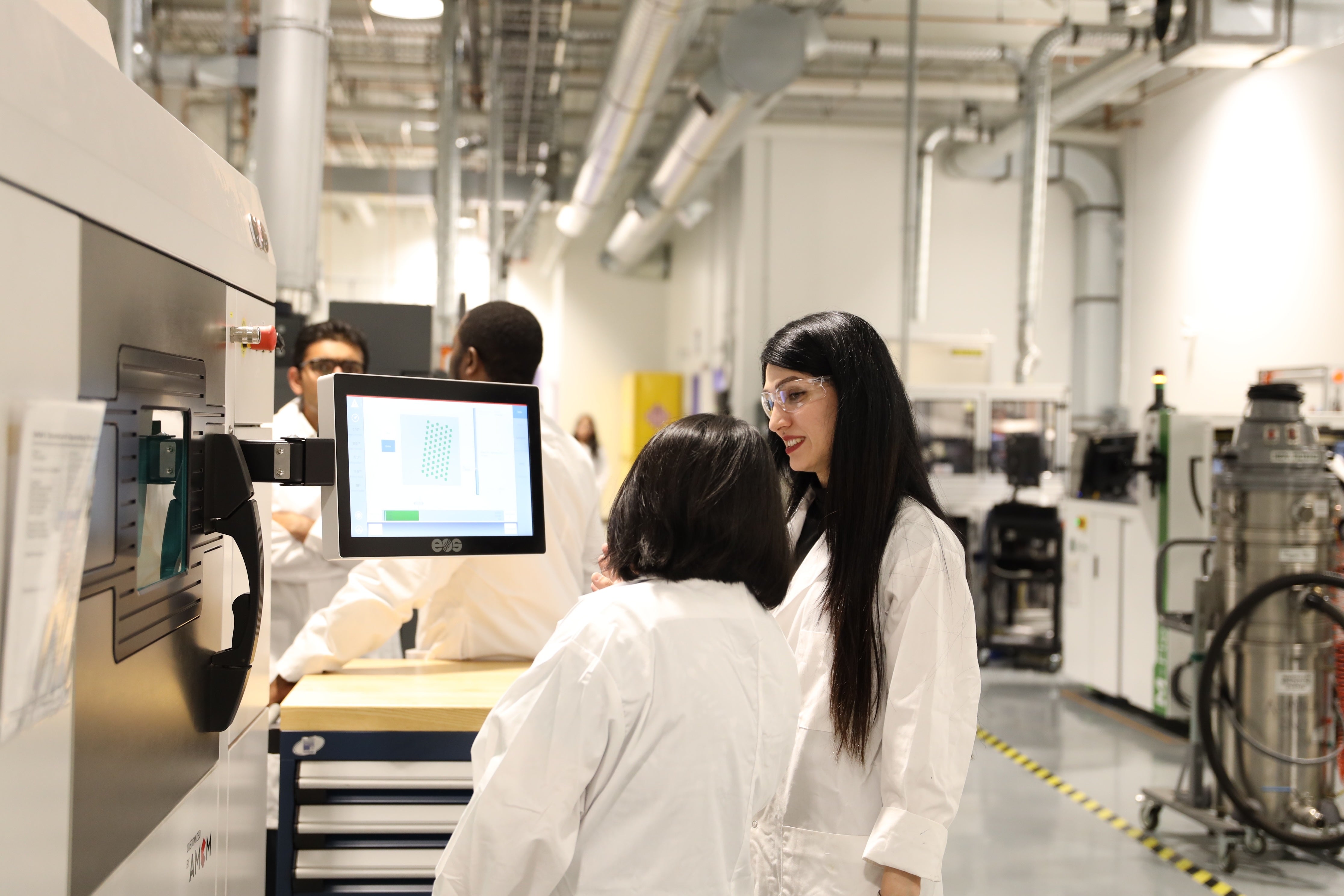 Researchers operating equipment in the MSAM Lab