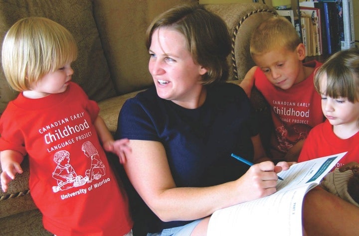 Woman speaking to several children