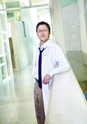 Alexander Wong in lap coat and blue tie