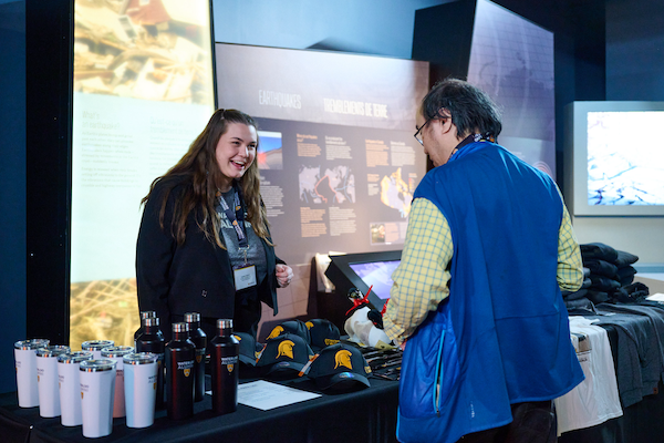 Alum interacting with a booth at the launch event