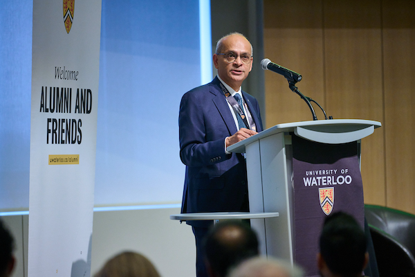 Vivek Goel standing at a podium on stage in Ottawa