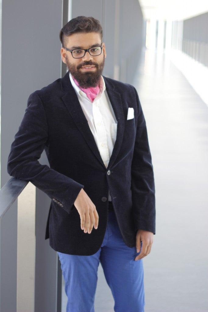 Andrew Andrade posing in a suit