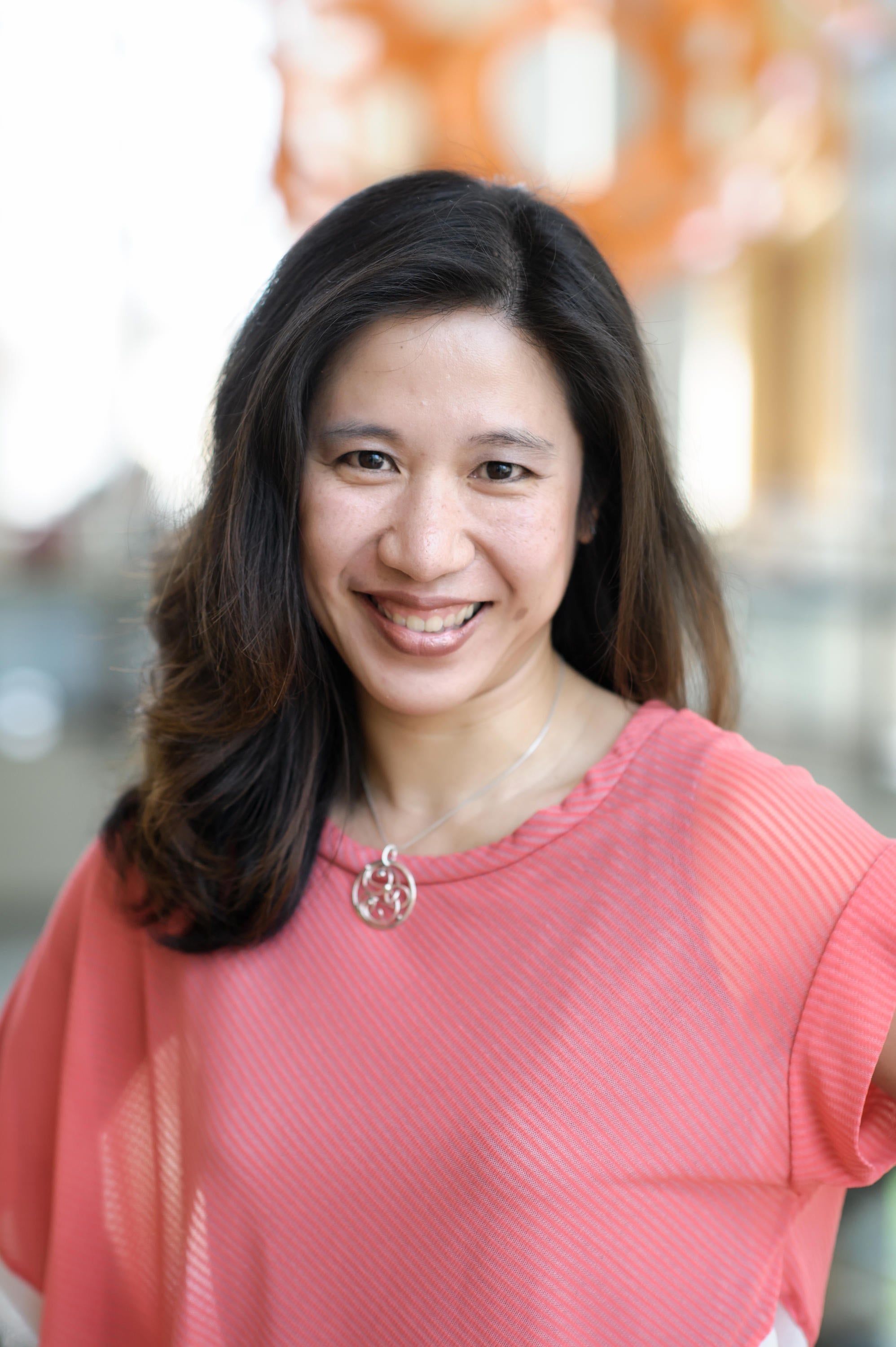 Profile photo of Anita Layton in a pink shirt with a silver necklace.