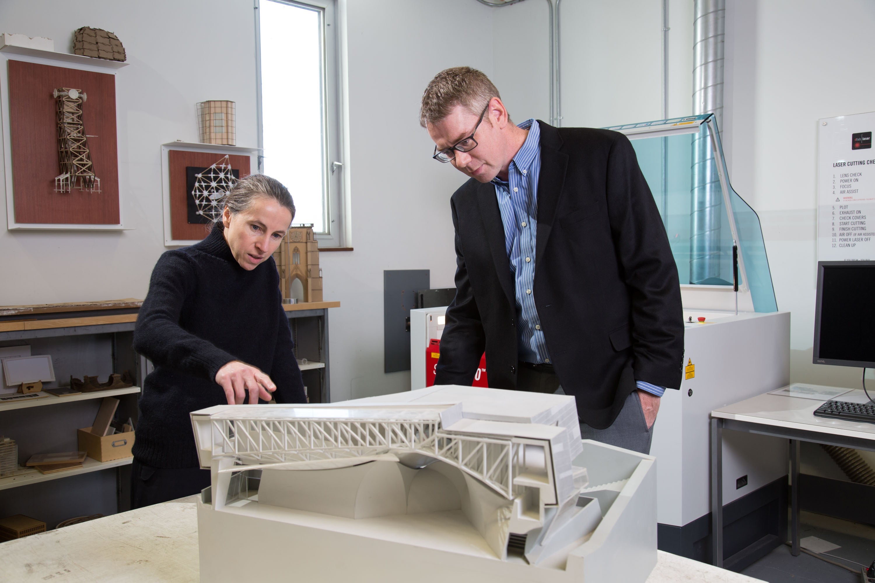 Two-architects-looking-at-building-model