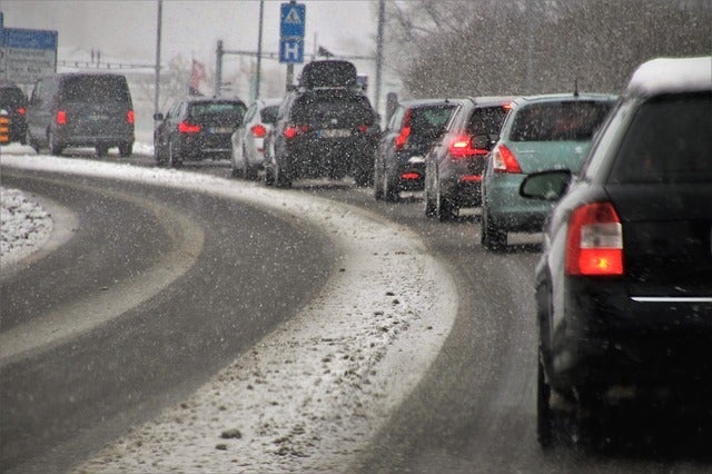 Cars driving in snowy weather.