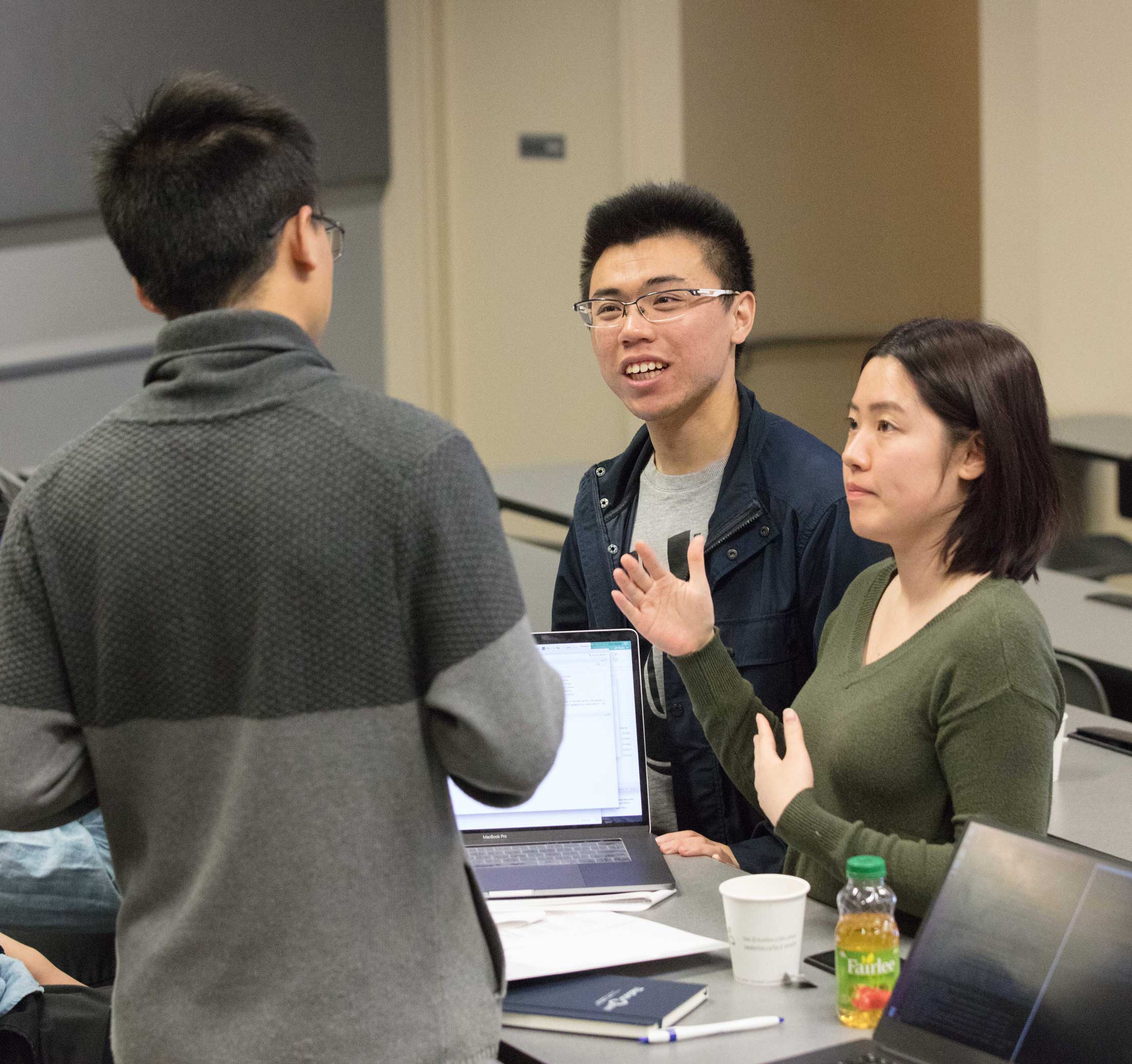 A group of four students discussing