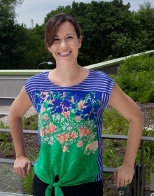 Sarah Burch leaning on a wall outdoors