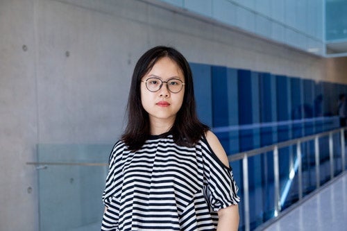 Jiayue Cheng standing in front of QNC staircase
