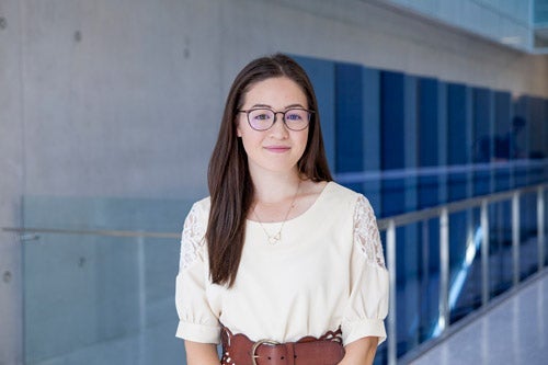Christina Sullivan standing in front of QNC staircase