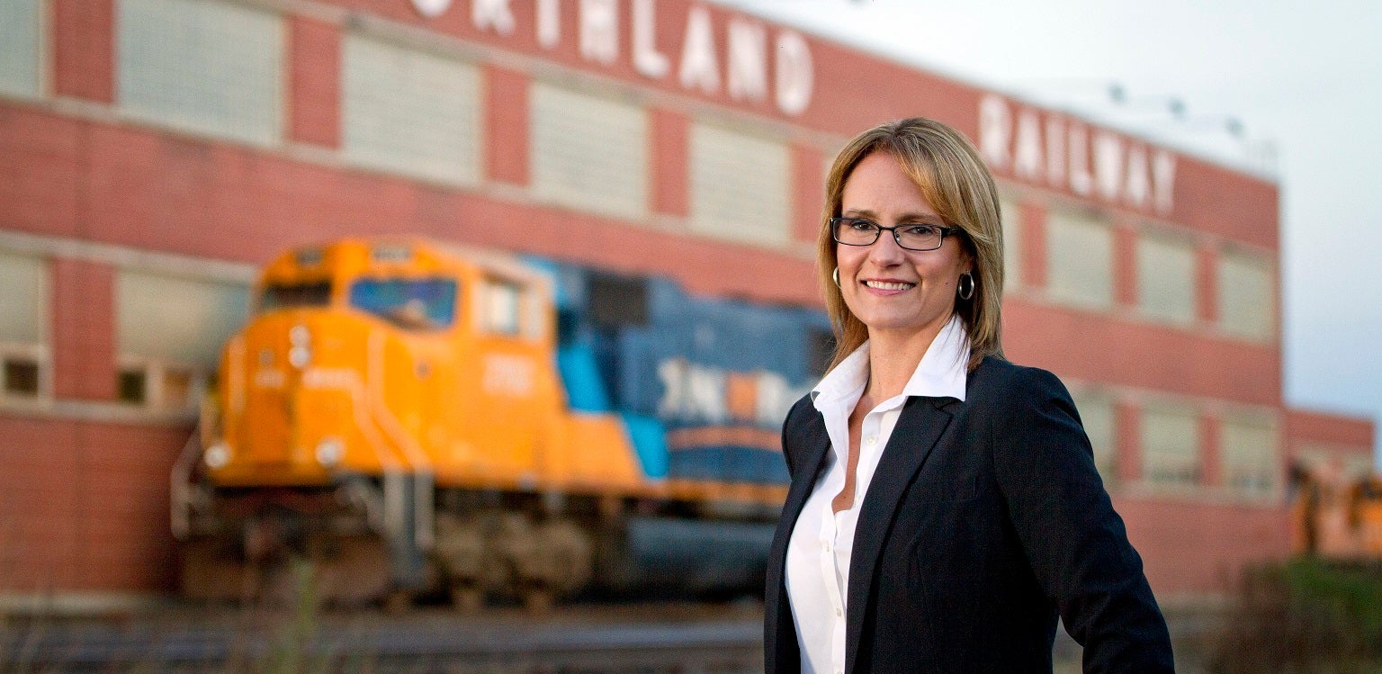 Cprina Moore stands beside train tracks