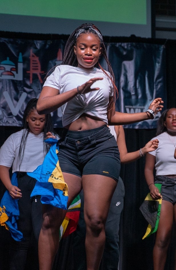 Tia Lewis dancing on stage with a group