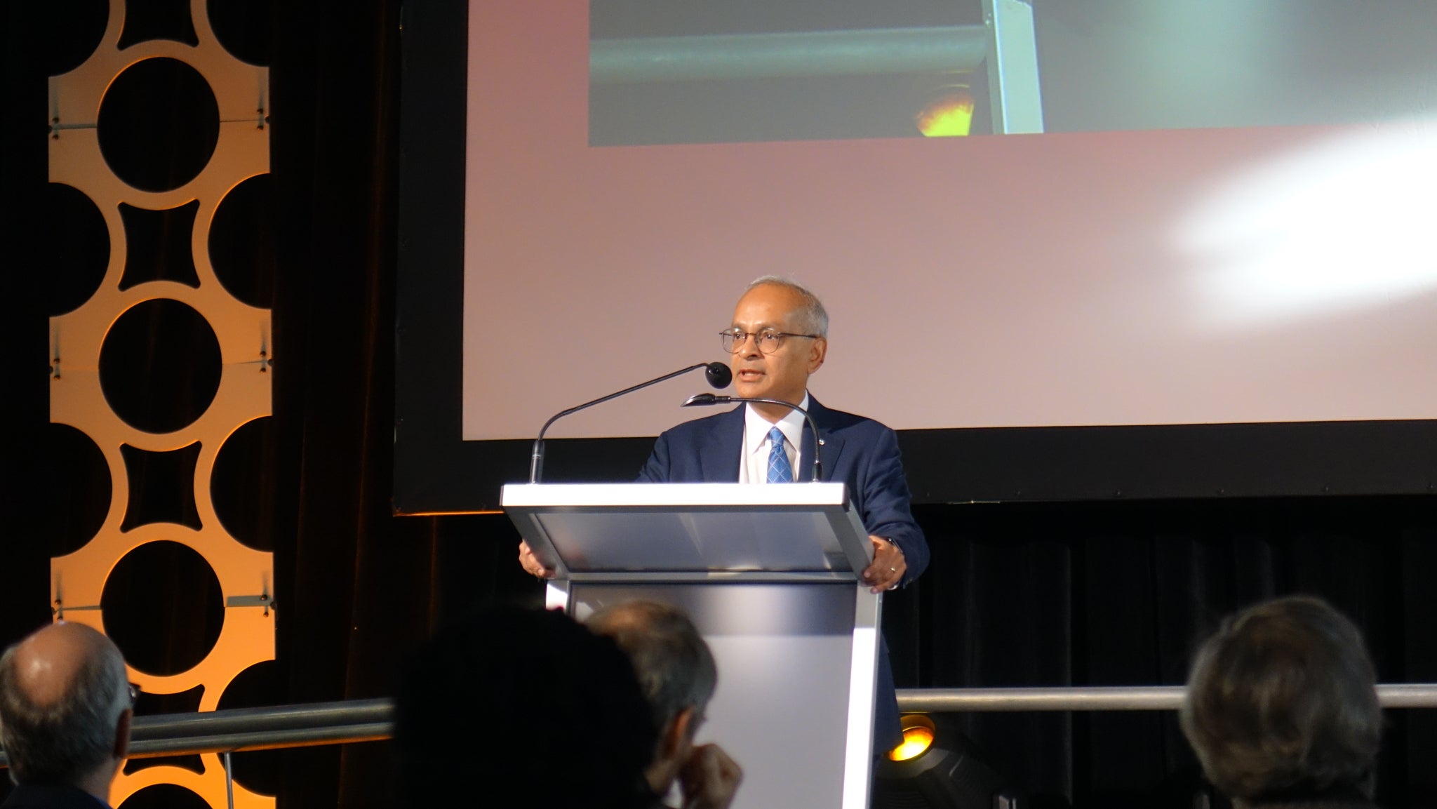 Dr. Vivek Goes speaking at the opening remarks of the symposium