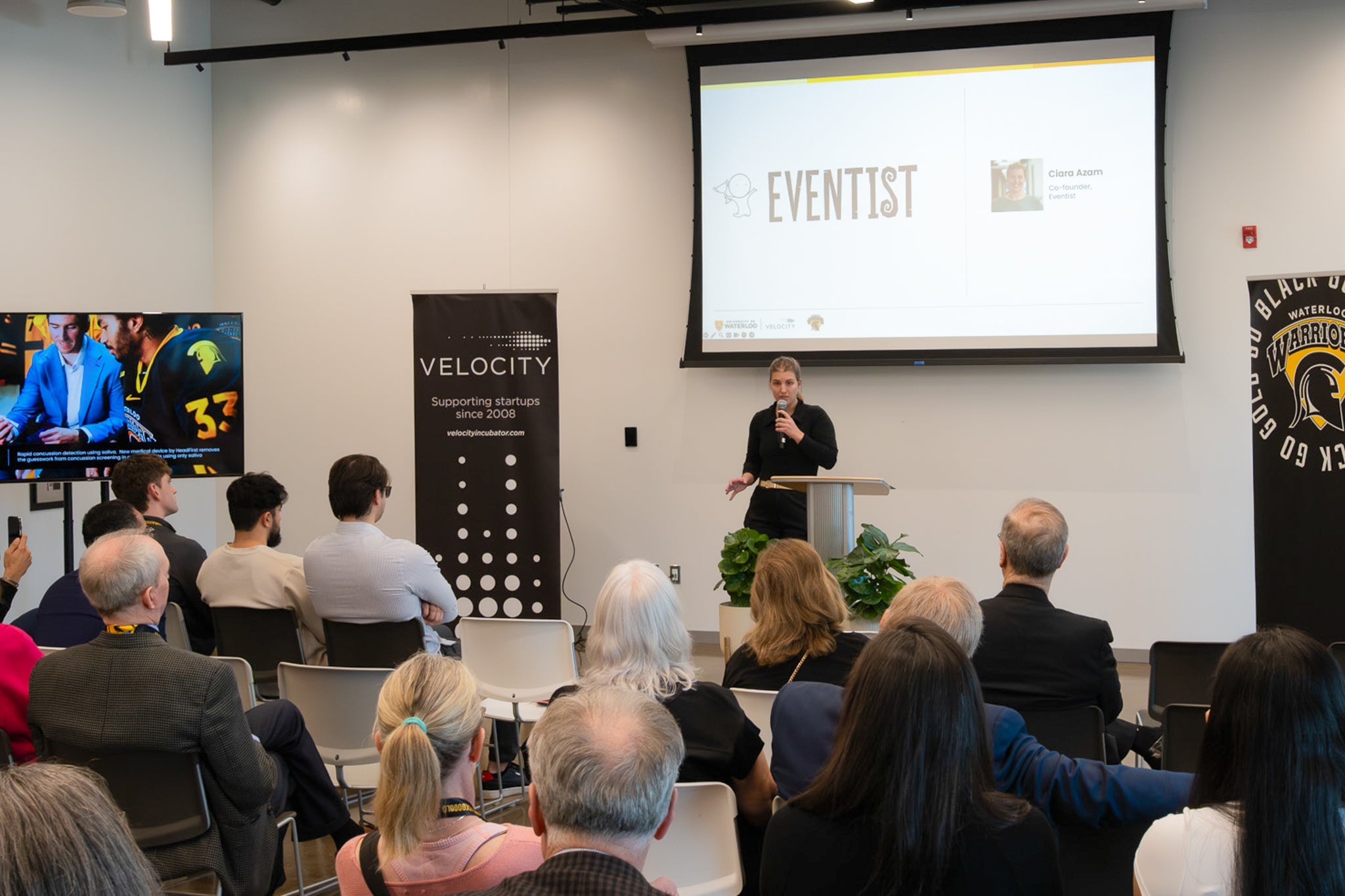Ciara Azam presenting Eventist in front of a room full of people inside Velocity's space in the Innovation Arena