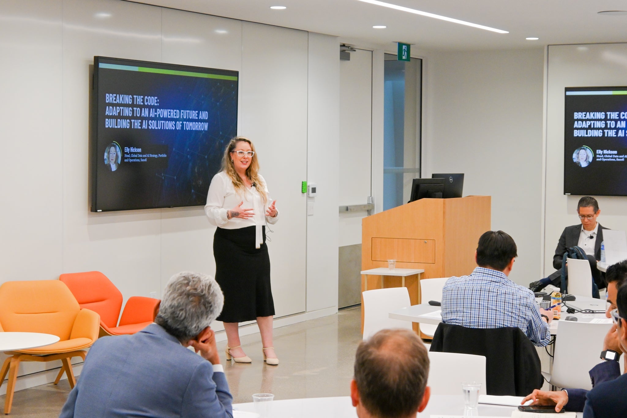 Eily Hickson speaking in front of a group of business and technology leaders