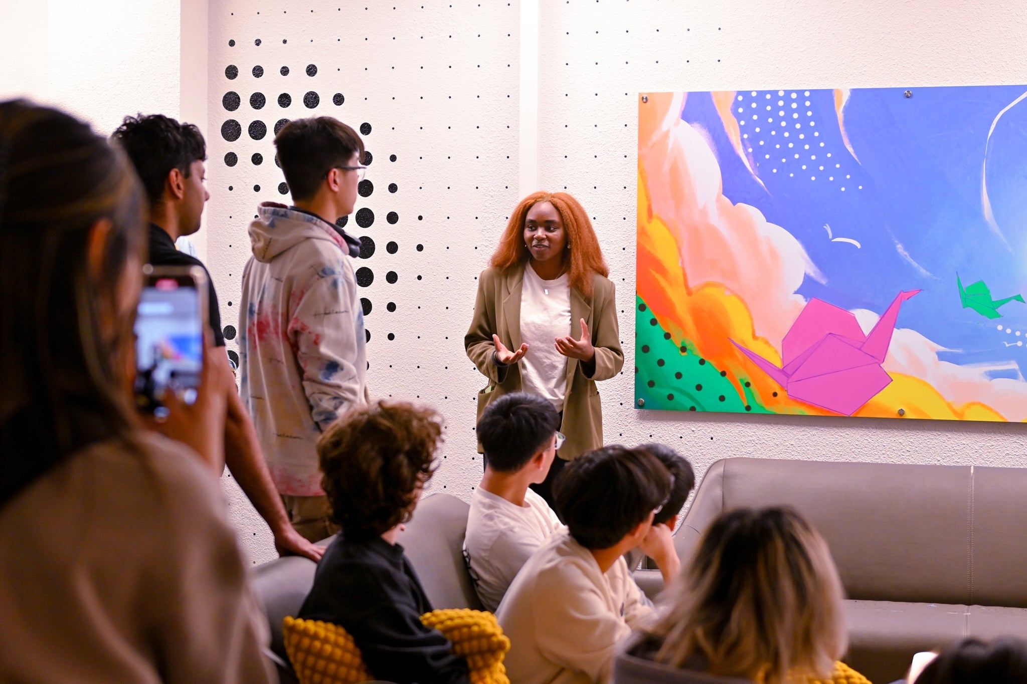 Waterloo alumni presenting a mural on the wall