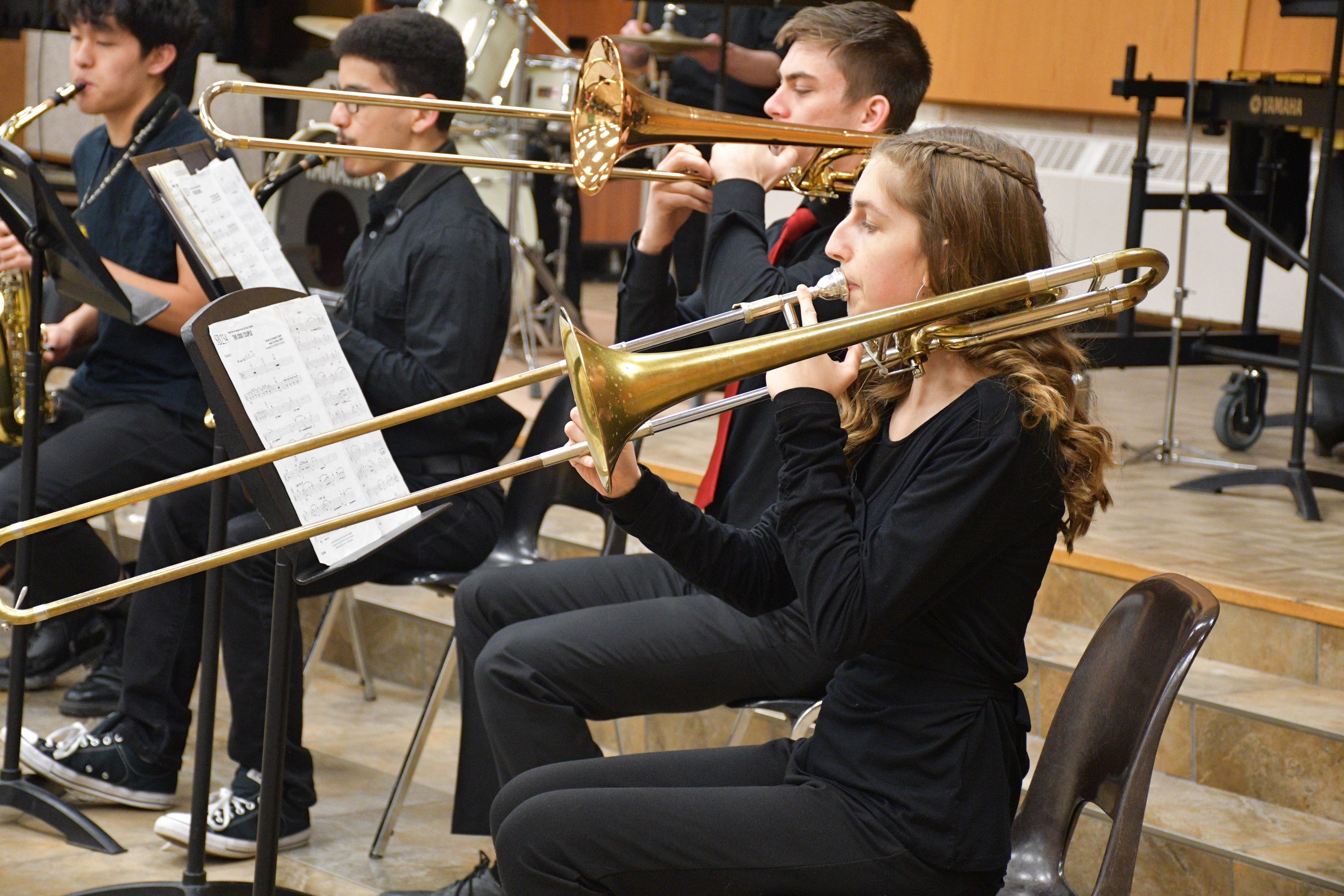 A woma plays the trombone