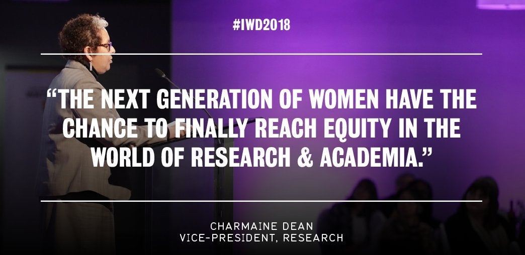 Dr. Charmaine Dean at the microphone addressing attendees of 2018 International Women's Day Dinner.