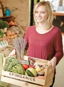 Emily Peat holding her EP Organics products
