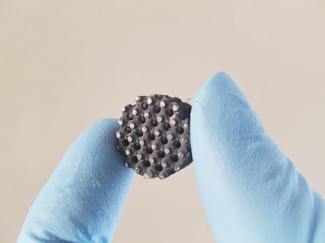fingers holding small device