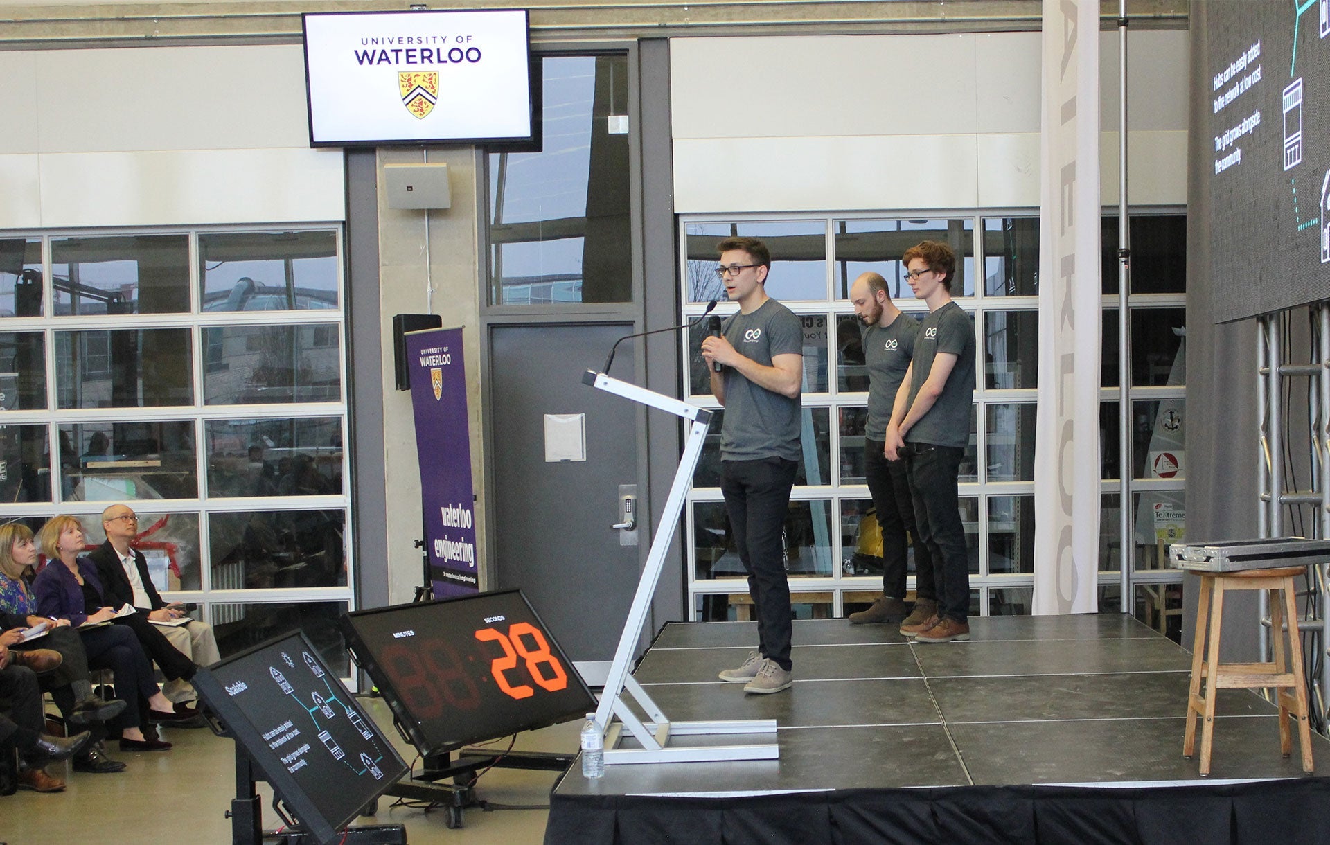 Circadian presenting on stage in front of a crowd of listeners.