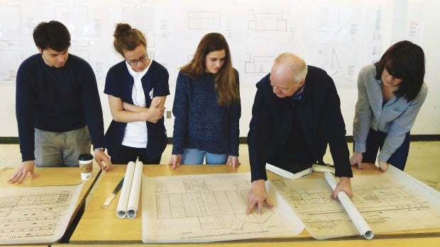 Waterloo Architecture students Alexandru Vilcu, Siobhan Allman, Anna Longrigg and Piper Bernbaum review the Auschwitz Crematorium Evidence Plans with professor Robert Jan van Pelt, second from right.